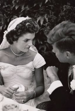Jacqueline Bouvier Kennedy and Sen. John F. Kennedy talk at their wedding reception in 1953.