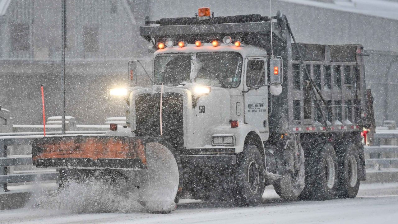 A truck with a plow drives over the Penn Street Bridge out of Reading, Pennsylvania, on Wednesday.