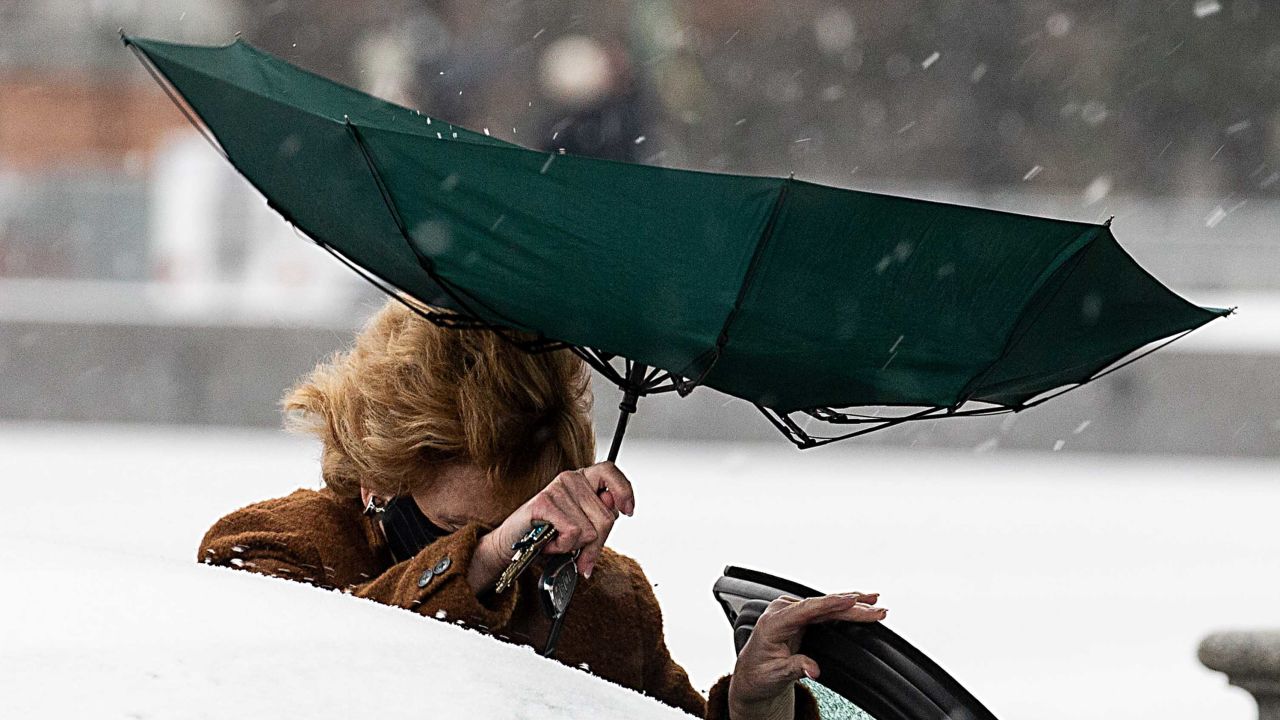 Sen. Debbie Stabenow (D-Michigan) struggles with her umbrella Wednesday at the US Capitol.
