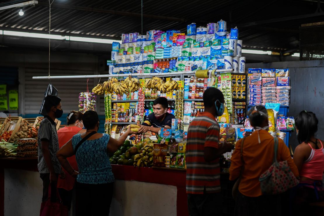 A vendor attends a stall at the municipal market of Chacao in Caracas on September 3, 2020.