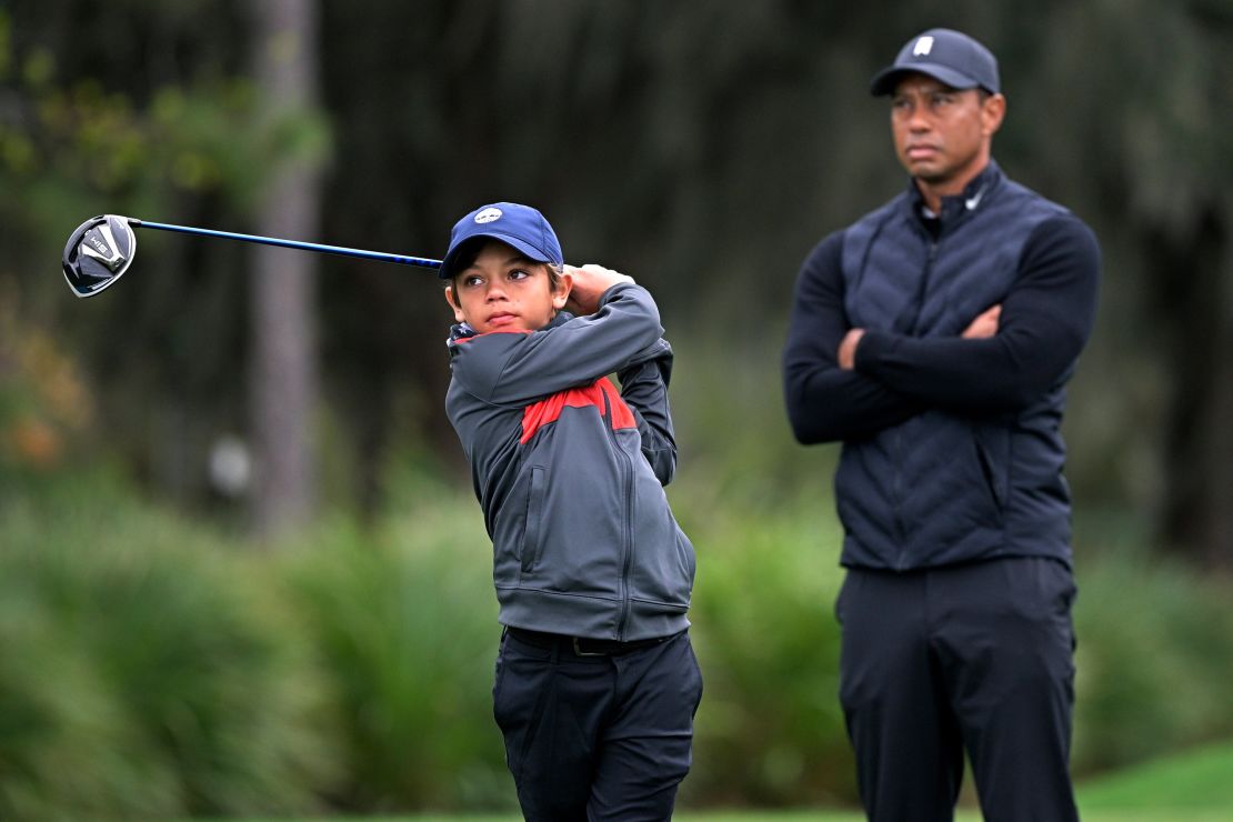 Tiger Woods watches as his son Charlie tees off.