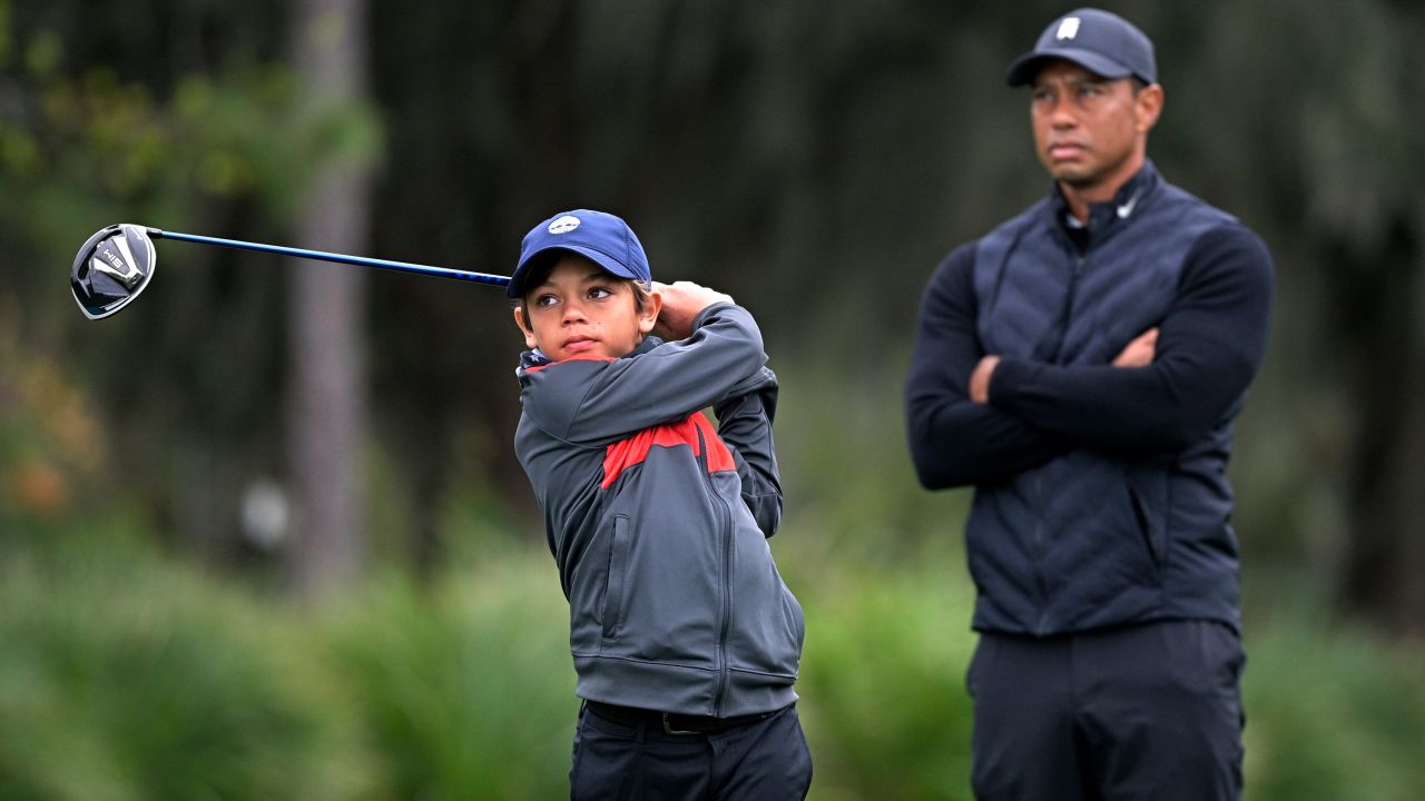 Tiger Woods watches as his son Charlie tees off.