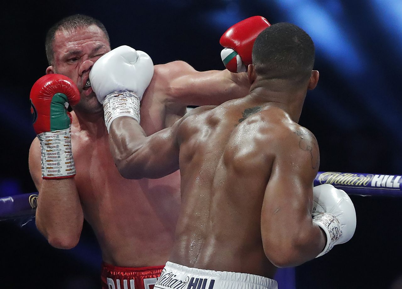Anthony Joshua punches Kubrat Pulev during their heavyweight title fight in London on Saturday, December 12. Joshua knocked out Pulev in the ninth round to retain his titles.