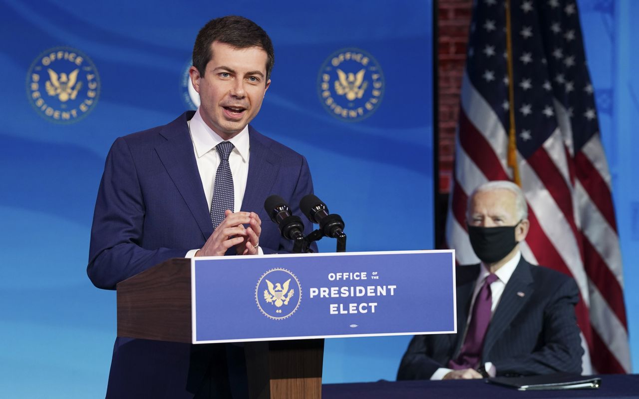 US President-elect Joe Biden looks on as Pete Buttigieg, <a href="https://www.cnn.com/2020/12/16/politics/biden-pete-buttigieg-event/index.html" target="_blank">his nominee for transportation secretary,</a> speaks at a news conference in Wilmington, Delaware, on Wednesday, December 16. Buttigieg, the former mayor of South Bend, Indiana, competed against Biden in the Democratic primaries.