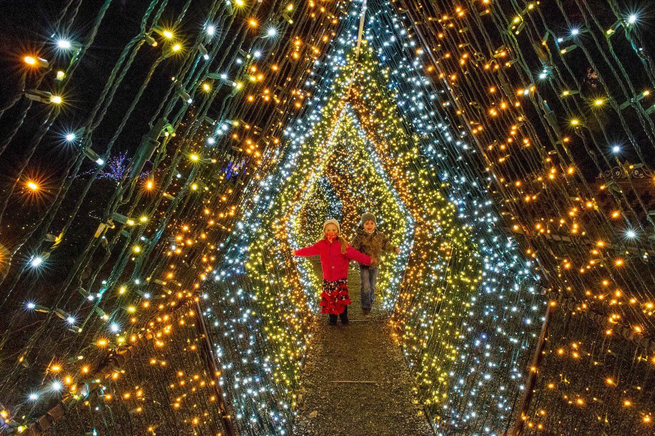 Two children walk through Christmas lights Sunday, December 13, at the Naumkeag museum in Stockbridge, Massachusetts. The town was recently ranked No. 1 on <a href="https://www.countryliving.com/life/travel/g2829/best-christmas-towns-in-usa/" target="_blank" target="_blank">Country Living magazine's best Christmas towns in the United States.</a>