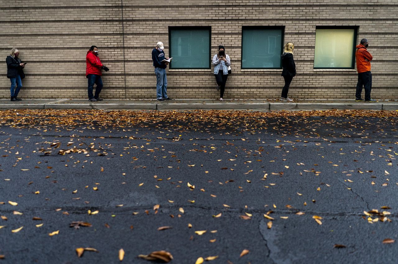 Voters line up outside the Ponce de Leon Library to vote in Atlanta on Monday, December 14. It was the first day of early voting for <a href="https://www.cnn.com/2020/11/05/politics/georgia-senate-jon-ossoff-david-perdue-kelly-loeffler-raphael-warnock/index.html" target="_blank">the runoff elections that will determine control of the US Senate.</a>