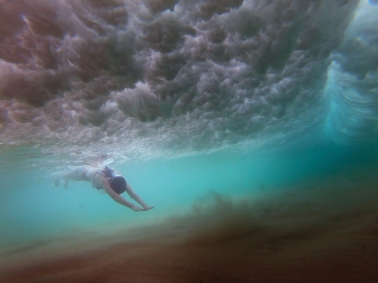A girl dives under a wave at Sydney's Bondi Beach on Thursday, December 17.