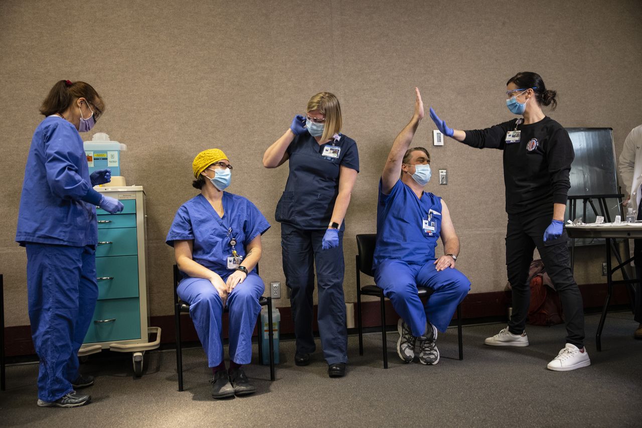 Health care workers react after they were given a Covid-19 vaccine in Portland, Oregon, on Wednesday, December 16.