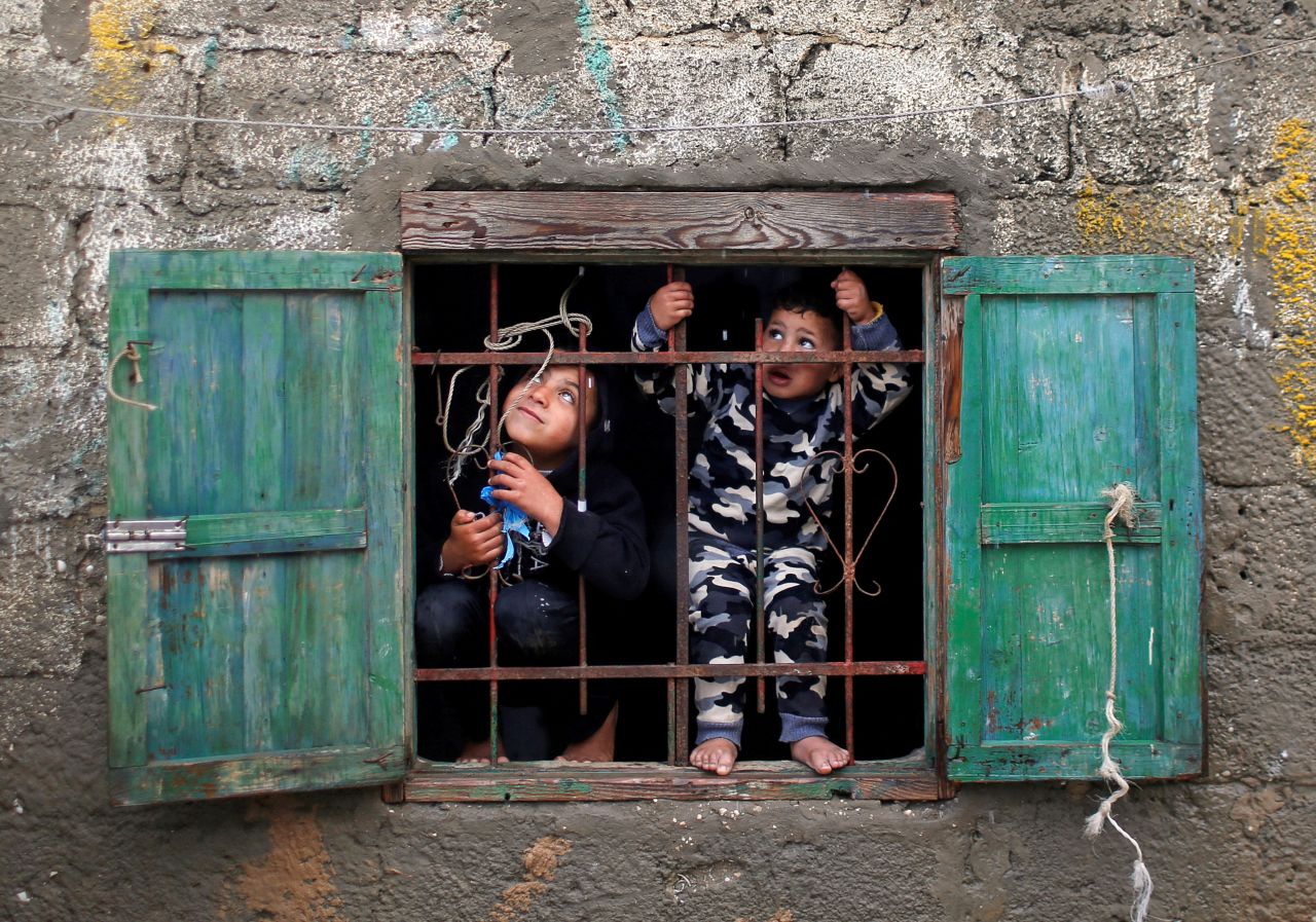Palestinian children look out of a window at the Deir al-Balah refugee camp in Gaza on Thursday, December 17.