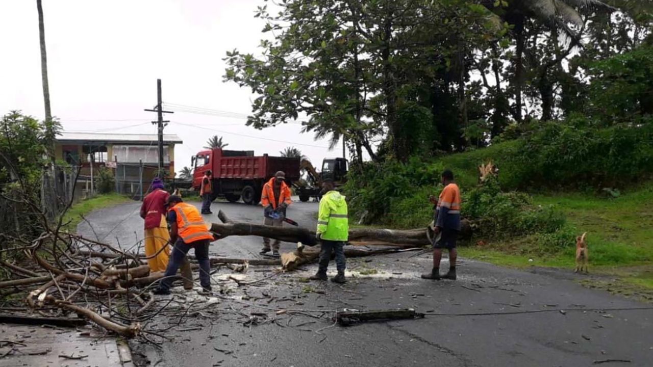People remove debris due to Cyclone Yasa at Velau Drive in Fiji, December 18, 2020, in this image obtained via social media.