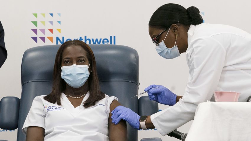NEW YORK, NY - DECEMBER 14: Sandra Lindsay, left, a nurse at Long Island Jewish Medical Center, is inoculated with the COVID-19 vaccine by Dr. Michelle Chester, December 14, 2020  in the Queens borough of New York City. The rollout of the Pfizer and BioNTech vaccine, the first to be approved by the Food and Drug Administration, ushers in the biggest vaccination effort in U.S. history. (Photo by Mark Lennihan - Pool/Getty Images)
