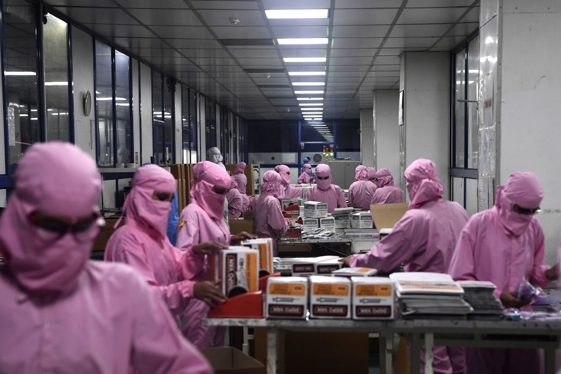 Workers pack syringes at the Hindustan Syringes factory, India's biggest syringe manufacturer, is ramping up production to churn out a billion units, anticipating a surge in demand.