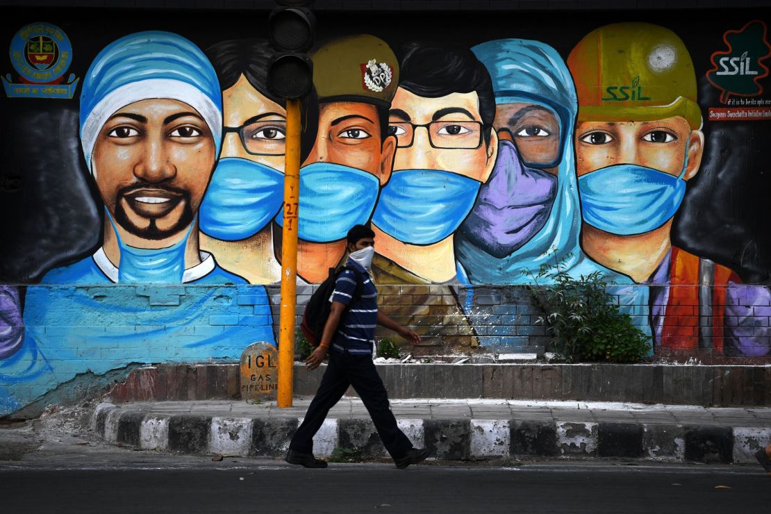 A man walks past a mural of frontline workers after the government eased a nationwide coronavirus lockdown in New Delhi on July 14.