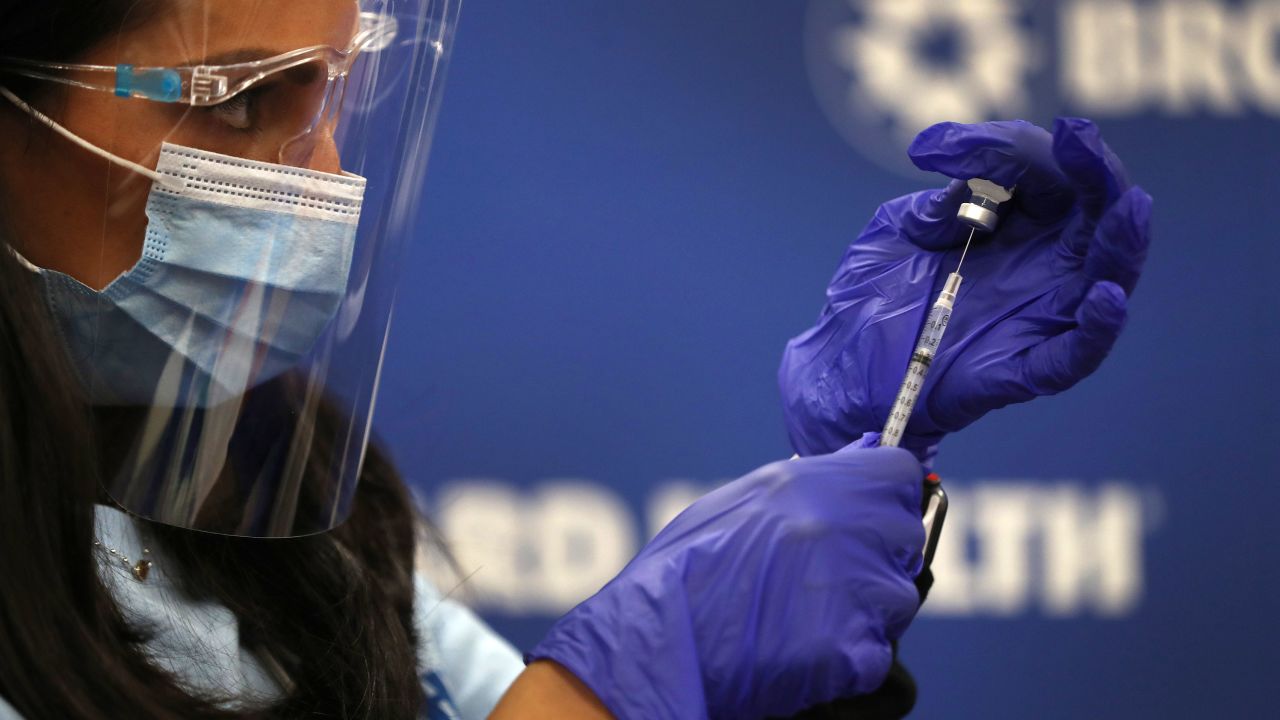 FORT LAUDERDALE, FLORIDA - DECEMBER 17:  Kristina Castro, Nurse Practitioner at Broward Health Medical Center prepares a Pfizer-BioNtech COVID-19 vaccine on December 17, 2020 in Fort Lauderdale, Florida.  Broward Health Medical Center began the vaccination of frontline healthcare workers joining with hospital systems around the country as the COVID-19 vaccine is rolled out. (Photo by Joe Raedle/Getty Images)