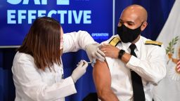 US Surgeon General Jerome Adams receives the COVID-19 vaccine in the Eisenhower Executive Office Building in Washington, DC, December 18, 2020. (Photo by SAUL LOEB / AFP) (Photo by SAUL LOEB/AFP via Getty Images)