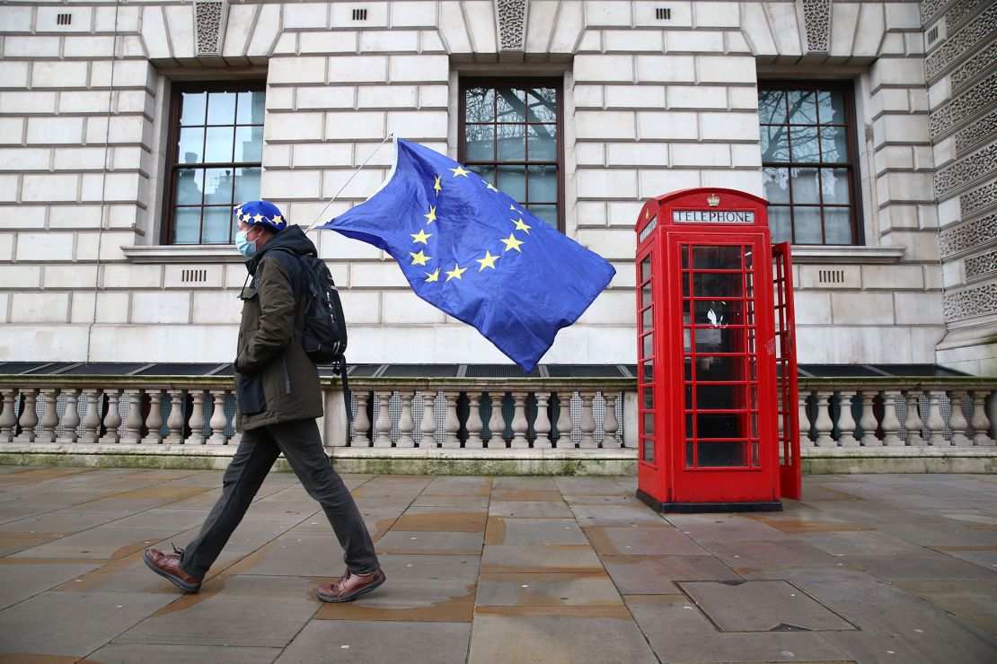 A man wearing an EU flag-themed beret and carrying an EU flag is seen on Whitehall in central London on December 11, 2020.