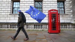 A man wearing an EU flag-themed beret and carrying an EU flag is seen on Whitehall in central London on December 11, 2020. - Prime Minister Boris Johnson on December 10 vowed to go the "extra mile" for a Brexit trade deal but instructed his government to prepare for Britain to crash out of the European Union's single market at the end of this year. (Photo by Hollie Adams/AFP/Getty Images)