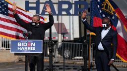 Former US President Barack Obama and Raphael Warnock wave to attendees during a Get Out the Vote rally as they campaign for Democratic presidential candidate former Vice President Joe Biden in Atlanta, Georgia on November 2, 2020.