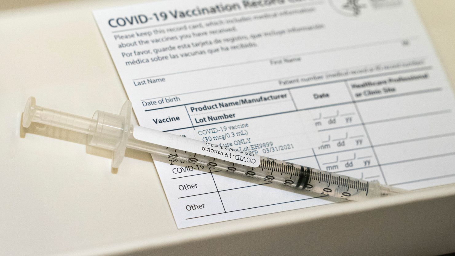 A syringe contains a dose of a Pfizer-BioNtech COVID-19 vaccine sits in a container, Wednesday, Dec. 16, 2020, during a vaccine clinic at Providence Alaska Medical Center in Anchorage, Alaska.