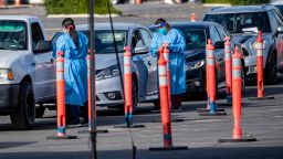 RIVERSIDE, CA - DECEMBER 9, 2020:  Drivers wait in a long line of cars for a COVID-19 test at a drive-through test site on December 9, 2020 in Riverside, California. Riverside County currently has 107,324 confirmed cases with 768 hospitalized and 172 of those people are in the ICU.(Gina Ferazzi / Los Angeles Times via Getty Images)