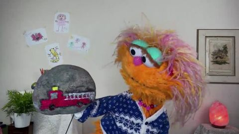 Zoe shows off a rock she painted to give to her local fire department.