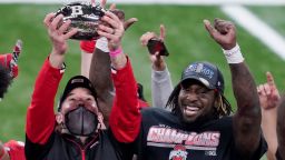 Ohio State head coach Ryan Day, left, holds the trophy along side running back Trey Sermon after defeating Northwestern in the Big Ten championship NCAA college football game, Saturday, Dec. 19, 2020, in Indianapolis. Ohio State won 22-10. (AP Photo/Darron Cummings)