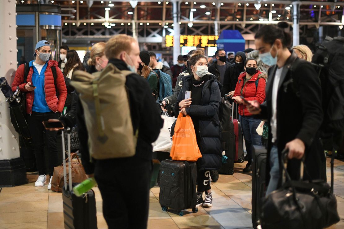 People wait on the concourse at Paddington Station in London on Saturday after the announcement that the capital would move into Tier 4 Covid-19 restrictions from midnight.