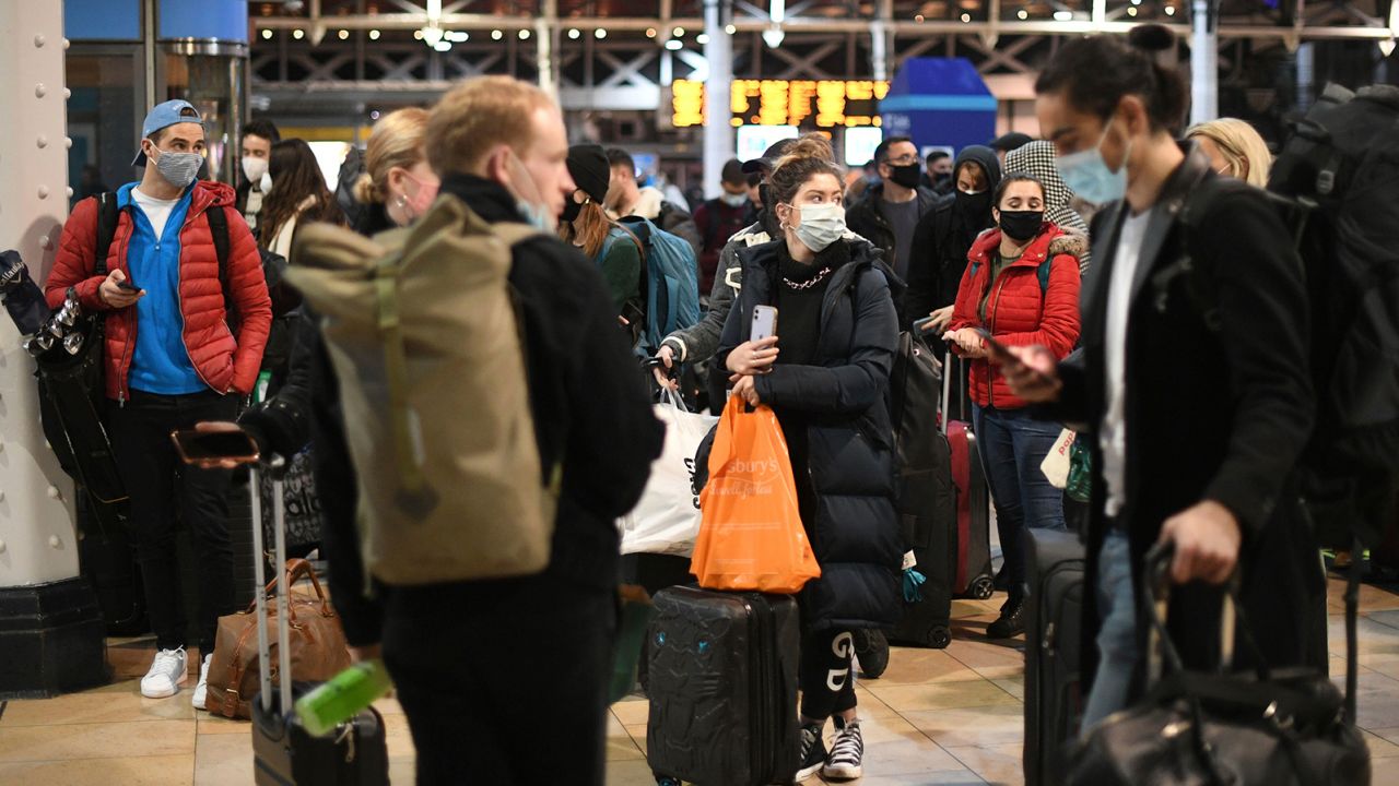 People wait on the concourse at Paddington Station in London on Saturday after the announcement that the capital would move into Tier 4 Covid-19 restrictions from midnight.