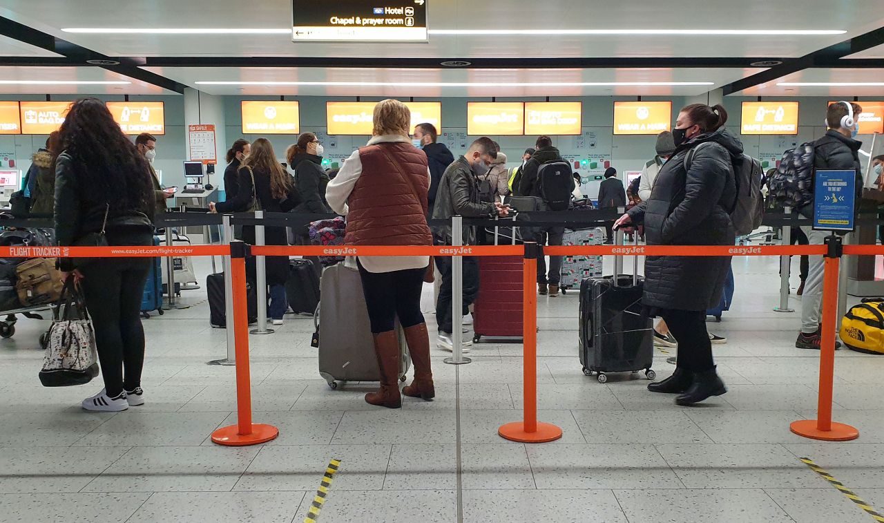 Passengers queue at Gatwick Airport in West Sussex.