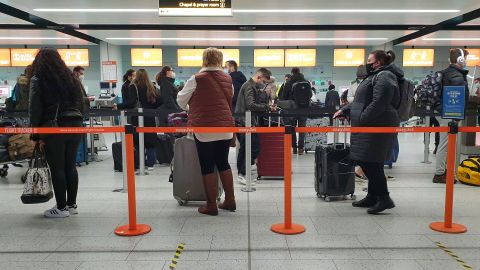 Passengers queue at Gatwick Airport in West Sussex.