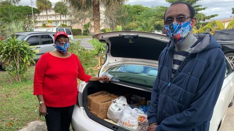 Julie and Leonard Thompson woke up at 3:45 a.m. to get in line for free food at a Boynton Beach, Florida, mall. They say they will deliver the  items to friends and neighbors.