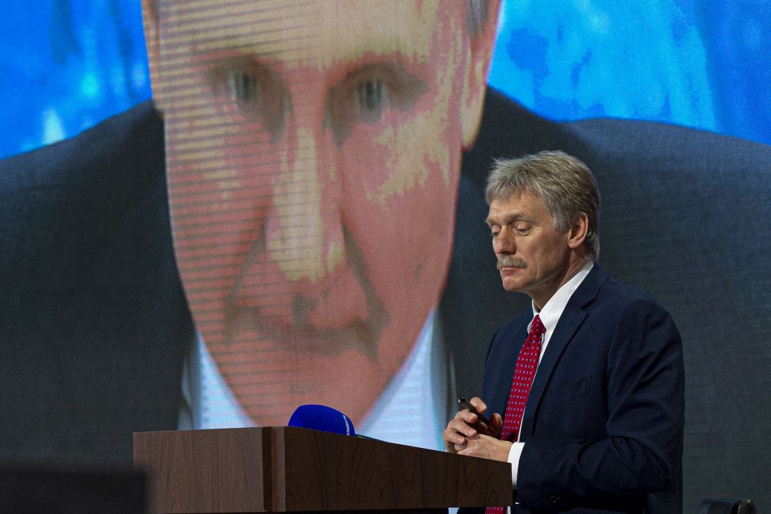 Kremlin spokesman Dmitry Peskov looks on as Russian President Vladimir Putin speaks via video at a news conference. Both have blamed Western intelligence agenices for being involved with Navalny.