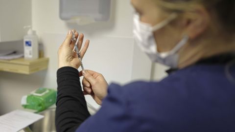 A healthcare worker prepares a Covid-19 vaccination dose in the UK.