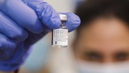 A nurse handles a vial of the the Pfizer-BioNTech Covid-19 vaccine at the Wolfson medical center in Holon, Israel, on Sunday, Dec. 20, 2020. Israelis returning from the U.K., Denmark, and South Africa will be sent to isolation in government-run quarantine sites to help prevent a mutant strain of coronavirus from entering the country. Photographer: Kobi Wolf/Bloomberg via Getty Images