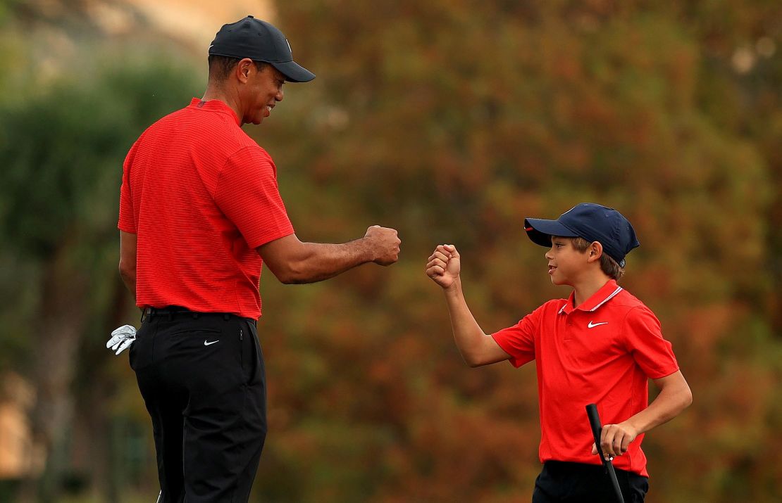 Tiger fist bumps Charlie on the 18th hole of the final round of the PNC Championship.