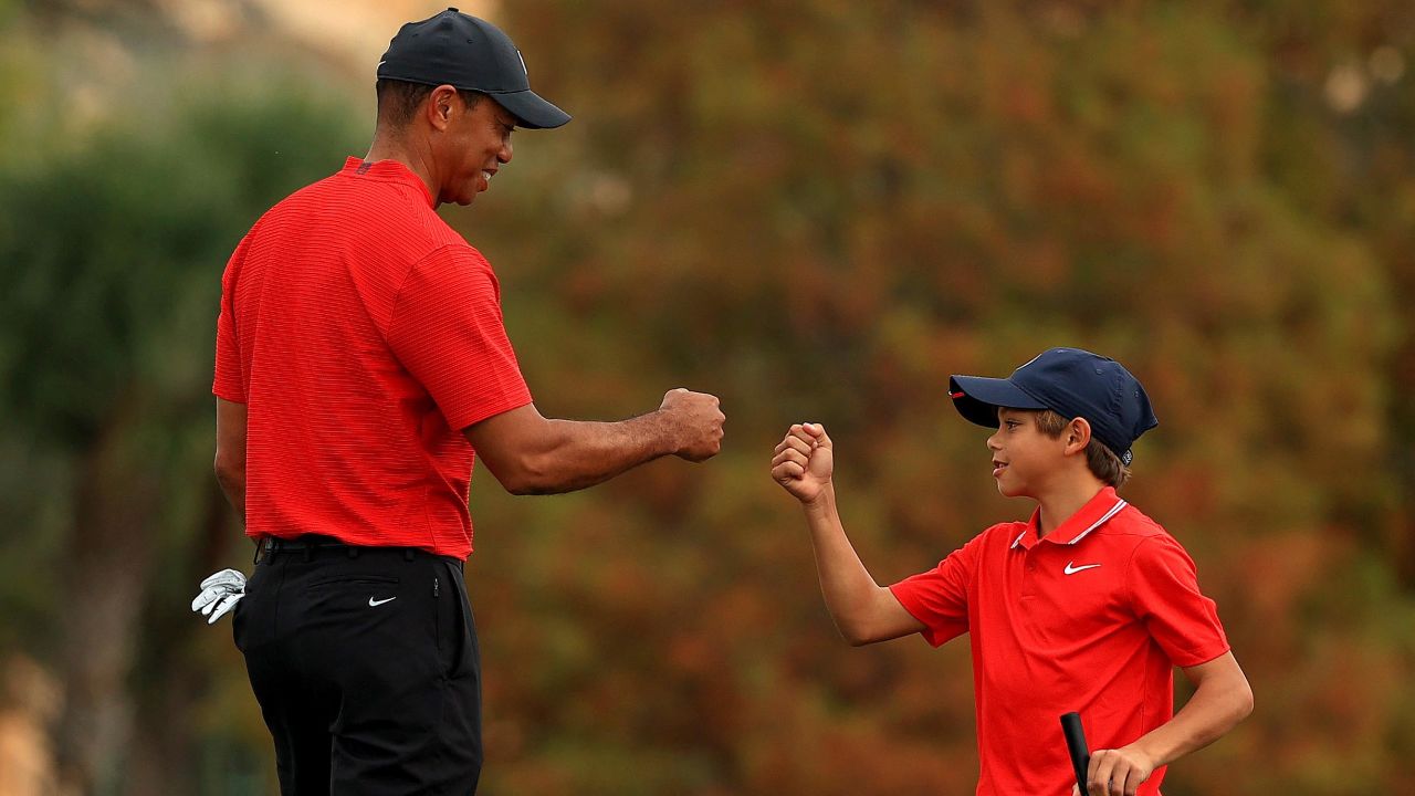 Tiger fist bumps Charlie on the 18th hole of the final round of the PNC Championship.