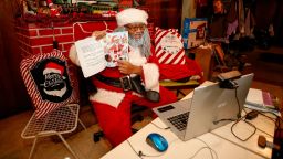 Andre Russel dressed as Santa Claus speaks to his client during virtual appointment in the basement of his home in Chicago, Illinois, on December 17, 2020. - As the pandemic rages, children's visits with Santa Claus are going virtual -- to protect both them and the men in high-risk groups who dress up as old St. Nick. (Photo by KAMIL KRZACZYNSKI / AFP) (Photo by KAMIL KRZACZYNSKI/AFP via Getty Images)