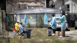 CHICAGO, ILLINOIS - JUNE 23: Workers talk residents through a COVID-19 self-test at a mobile COVID-19 testing site set up on a vacant lot in the Austin neighborhood on June 23, 2020 in Chicago, Illinois. The site is one of four mobile testing sites, two community-based sites and two first-responder-focused sites being implemented by the city.  (Photo by Scott Olson/Getty Images)