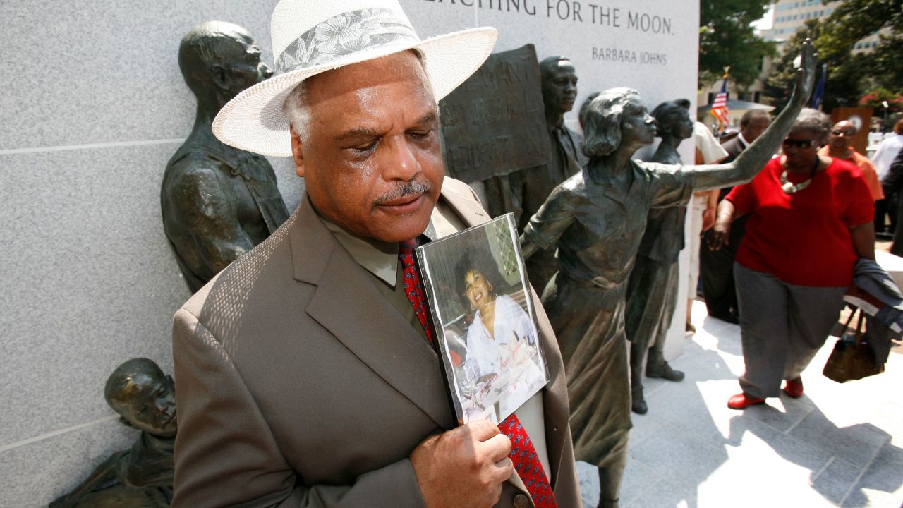 Roderick Johns, brother of civil rights activist Barbara Johns, holds a photo of his sister at the Virginia Civil Rights Memorial on the grounds of the State Capitol in Richmond on July 21, 2008.  