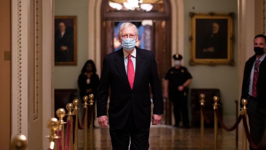 US Senate Majority Leader Mitch McConnell (C) walks near the Senate floor on Capitol Hill in Washington, DC, USA, 21 December 2020. United States congressional leaders are trying to pass a coronavirus stimulus and relief package worth approximately 900 billion US dollars. The COVID-19 stimulus relief package has been tied to a funding bill that would fund the government through September 2021.