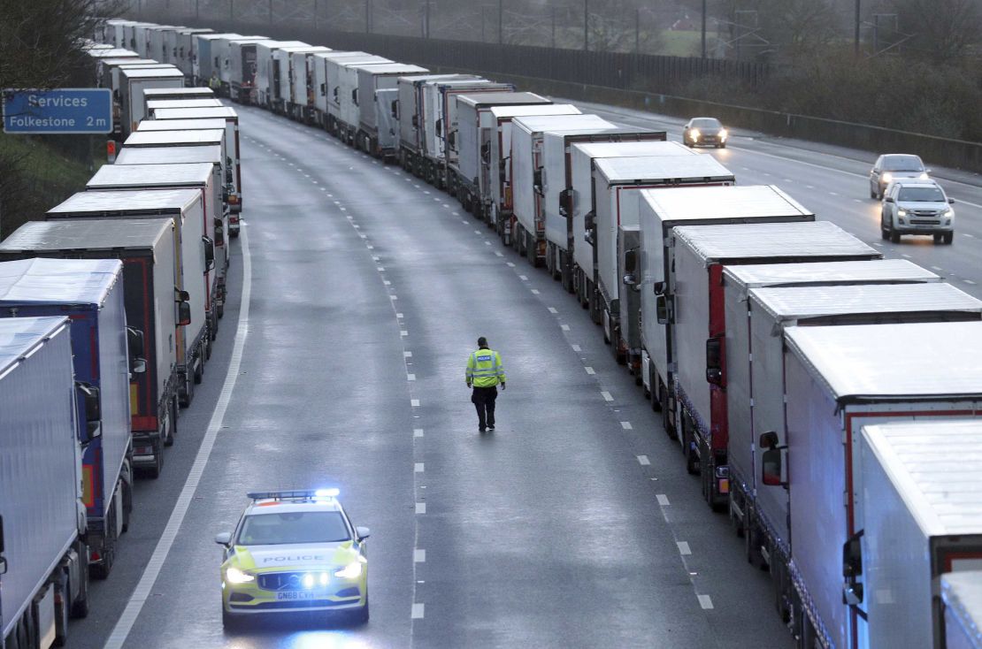 Police patrol along the M20 motorway where freight traffic is parked whilst the port of Dover remains closed on Tuesday.