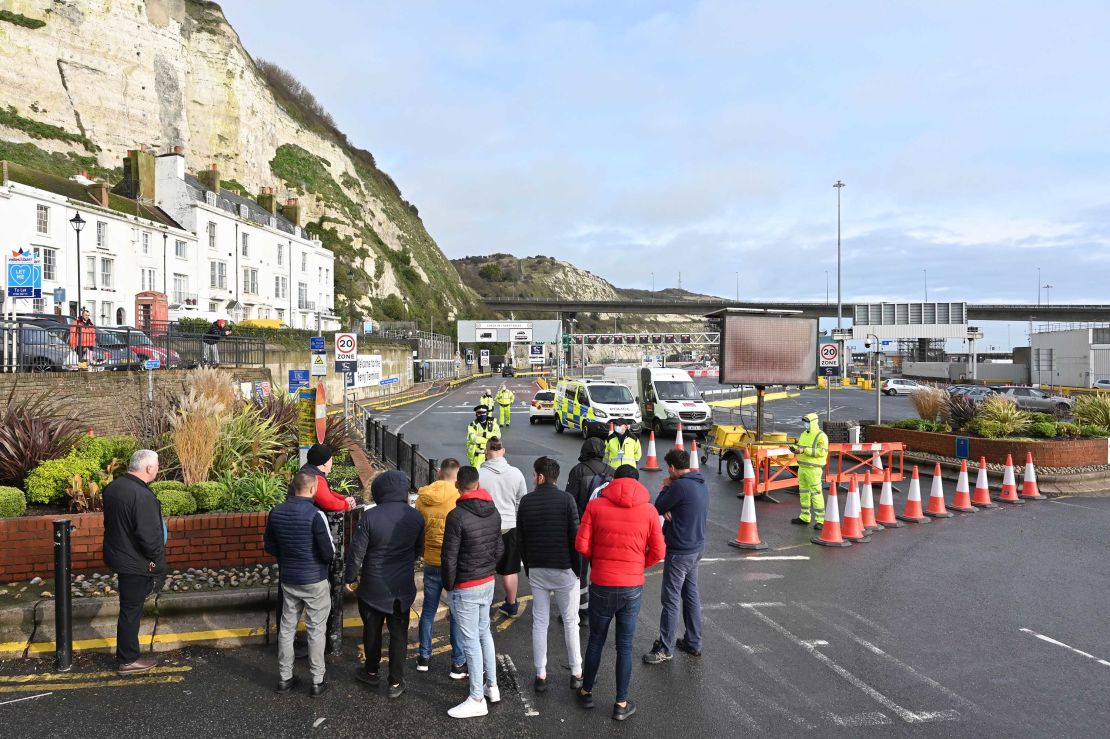 Drivers gather at the cordon blocking the entrance to the ferry terminal at the port of Dover in Kent, southeast England on Tuesday.