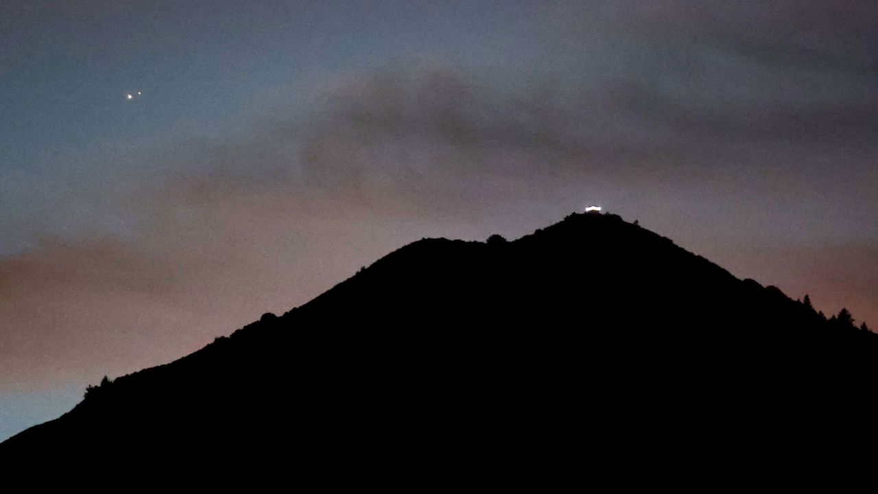 Jupiter, left, and Saturn appear about one-tenth of a degree apart above Mount Tamalpais on Monday in Larkspur, California. 
