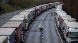SELLINDGE, ENGLAND - DECEMBER 22: Lorries are stacked along the M20 motorway as the border to France is closed on December 22, 2020 in Sellindge, United Kingdom. Nearly 1000 lorries remained stacked up in Kent as drivers waited for a resumption of travel from the port of Dover to France. On Sunday, France abruptly halted freight and passenger travel from the UK over concerns about the UK's surging covid-19 cases and a new variant of the virus. (Photo by Chris J Ratcliffe/Getty Images)