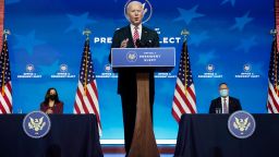 President-elect Joe Biden, with Vice President-elect Kamala Harris, seated left, introduces his nominee for Secretary of Education, Miguel Cardona, at The Queen Theater in Wilmington, Del., Wednesday, Dec. 23, 2020. 