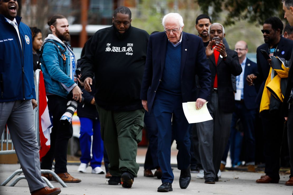 Killer Mike walks with Sen. Bernie Sanders before a campaign event in February, ahead of the presidential primary. 