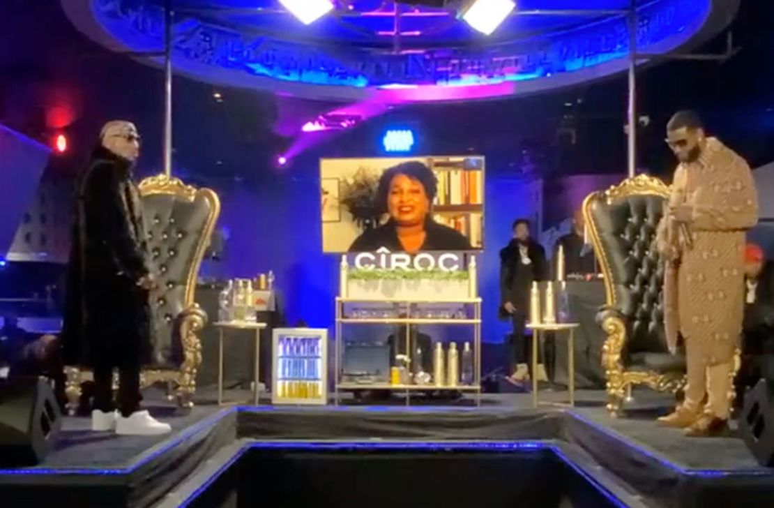 Before their Verzuz battle in November, Jeezy, left, and Gucci Mane stand on stage at Magic City as Stacey Abrams urges the audience to vote.