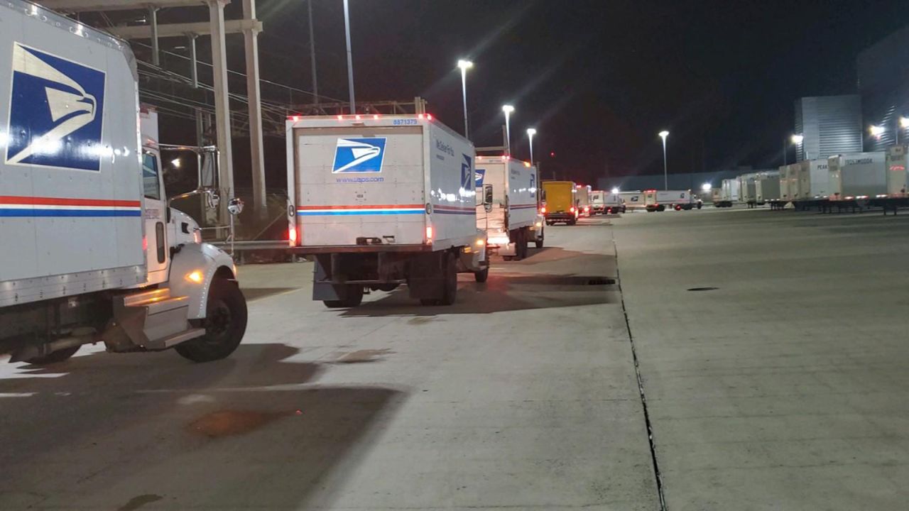 Mail trucks queue outside the USPS Philadelphia Processing and Distribution Center.  