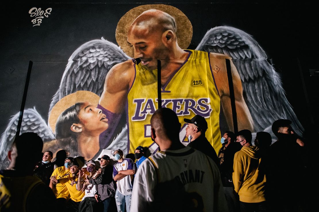 Lakers fans stand in line to celebrate in front of a mural of Kobe Bryant and his daughter on October 11, 2020 in Los Angeles, California.