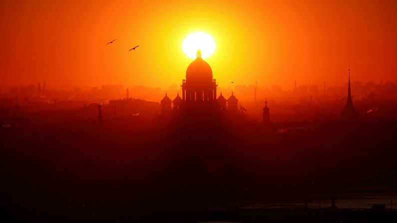 <strong>St. Petersburg, Russia:</strong> The sun sets behind St. Isaac's Cathedral, which was designed by French architect Auguste de Montferrand.